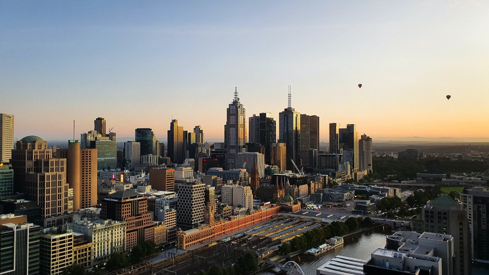 Hot air balloons over Melbourne CBD at sunrise
