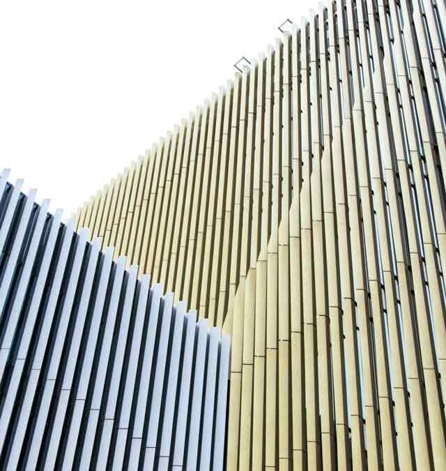 Yellow and white exterior panels of a Melbourne office building